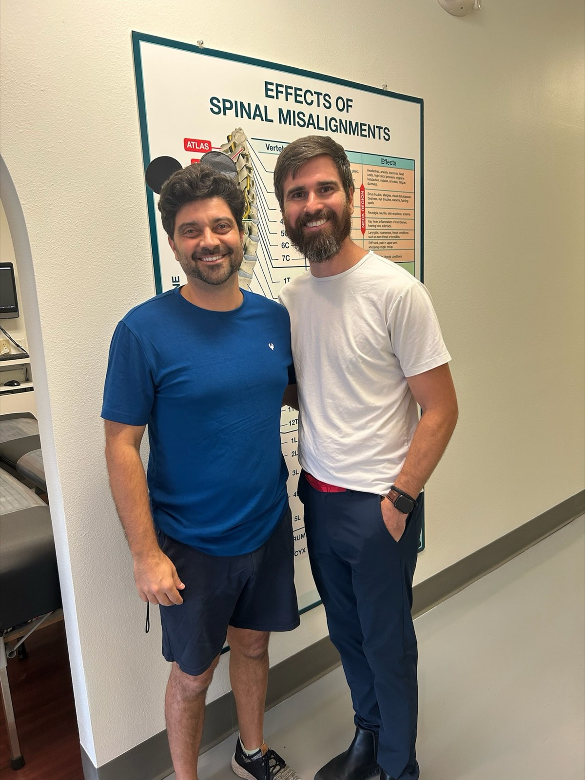 Dr. Logan reviews the spine chart with a smiling patient.
