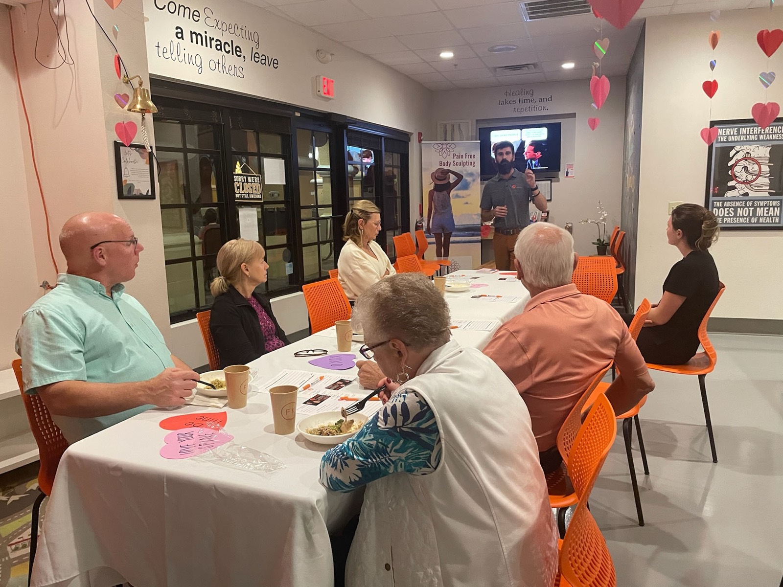 Dr. Logan presents to a table of guests at a neuropathy dinner seminar.