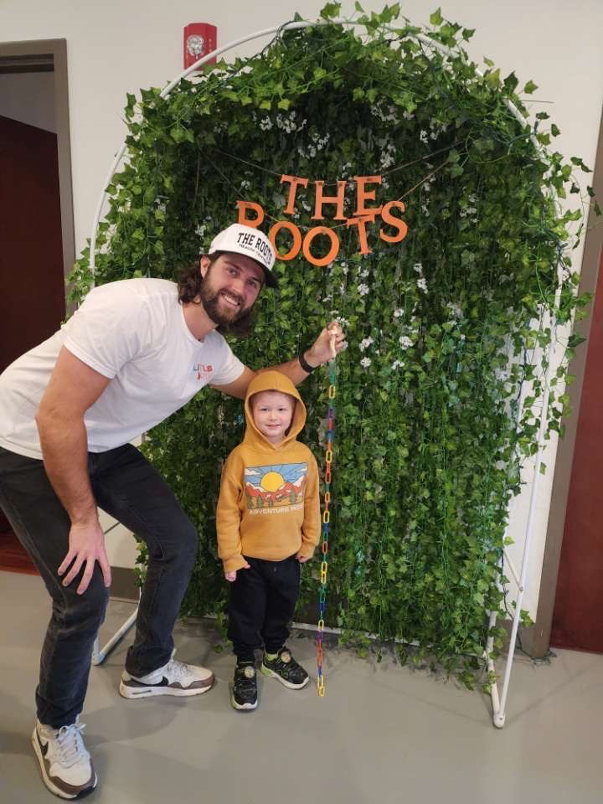 Dr. Logan with his son at The Roots' family day event.