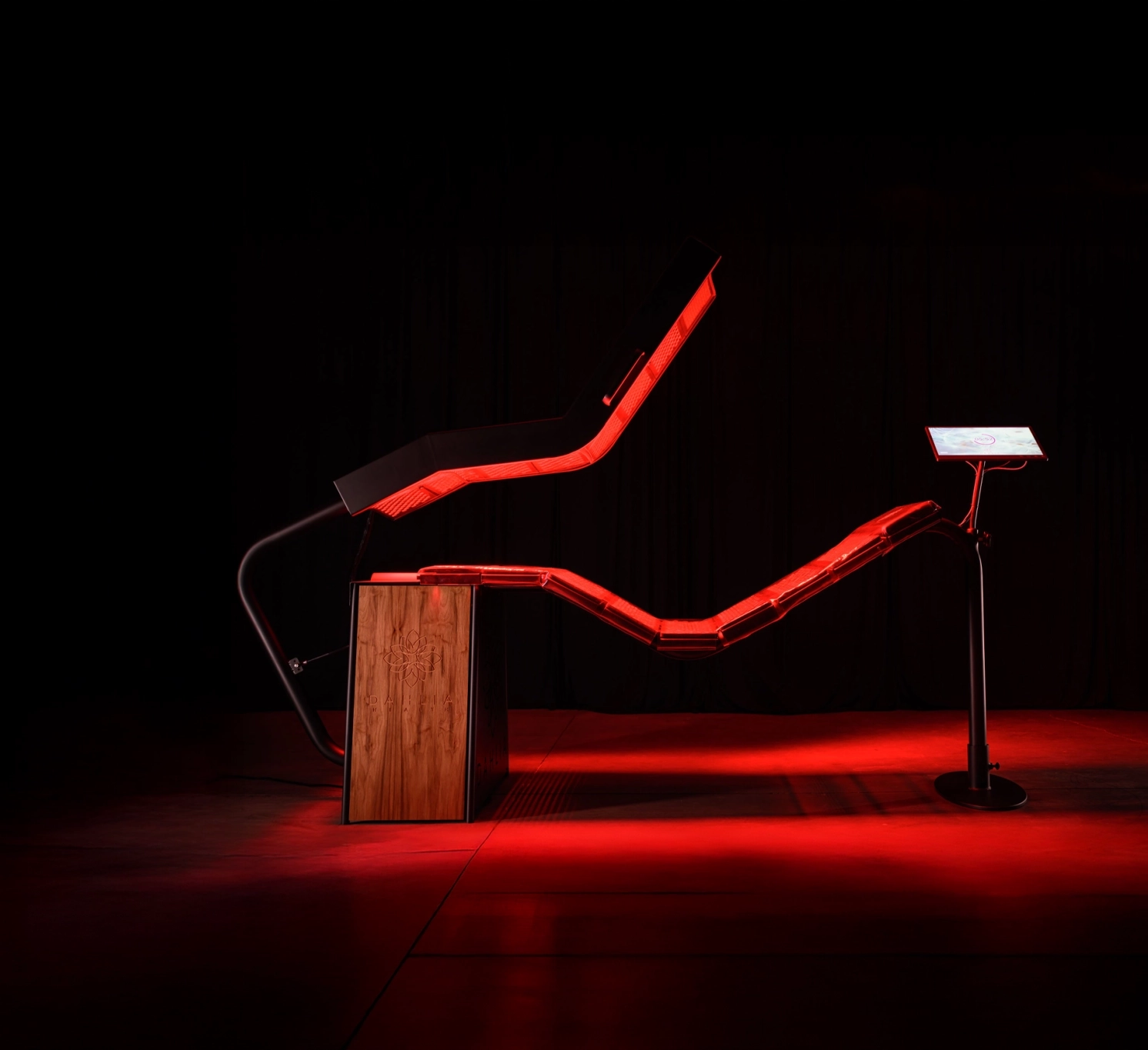 The DAHLIA Pinnacle Bed at The Roots Health Centers — side profile with red light spilling onto the floor.