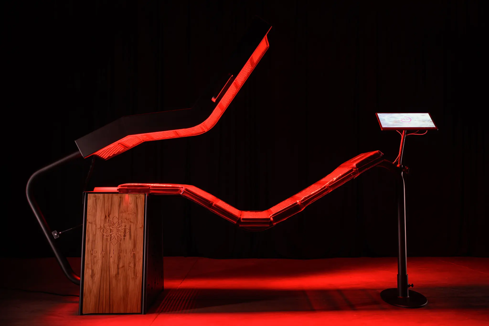 The DAHLIA chaise from a slightly elevated 3/4 angle, showing the curved panel arrangement.