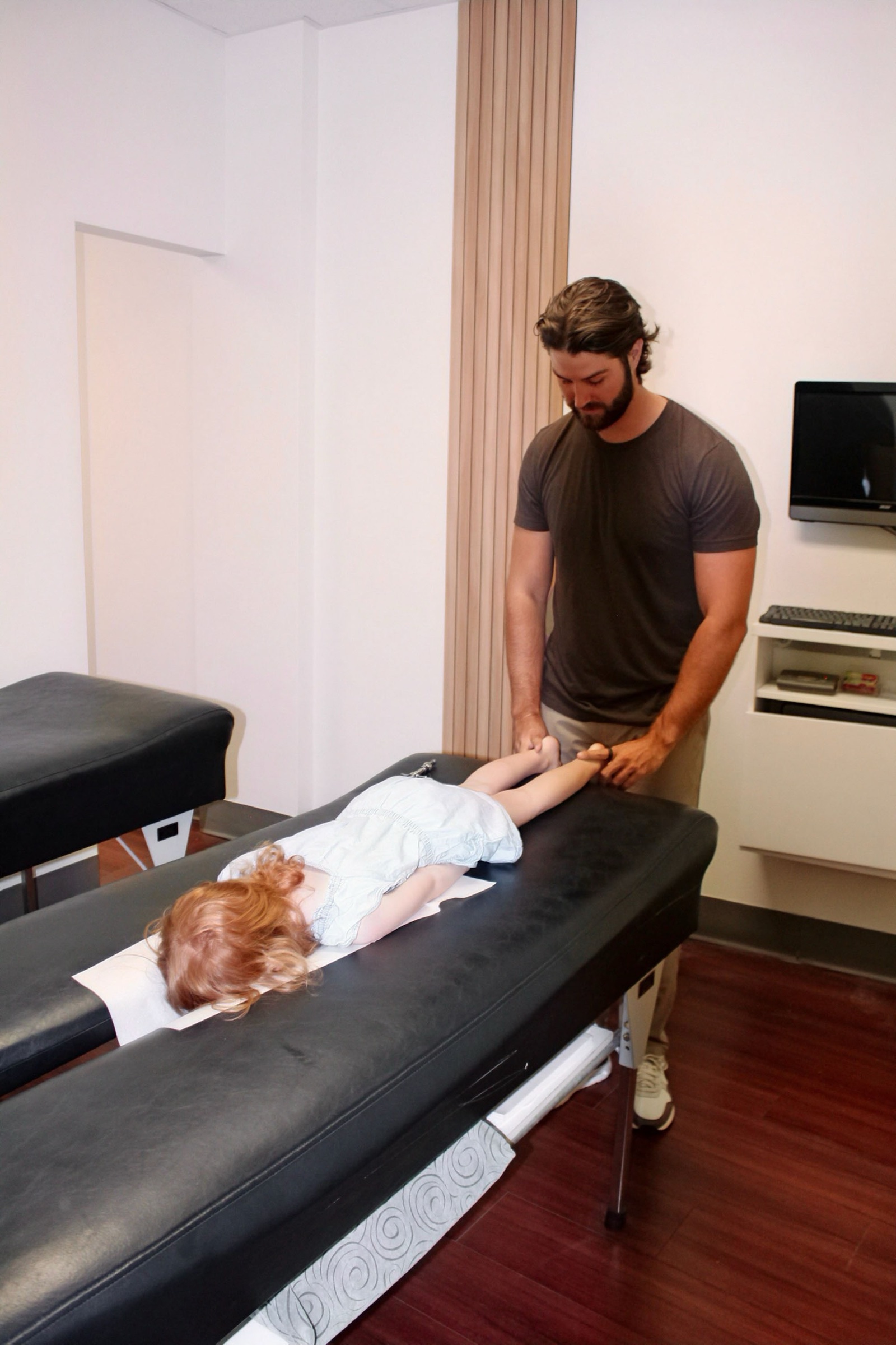 Dr. Grayson Fox performs a gentle adjustment on a toddler.