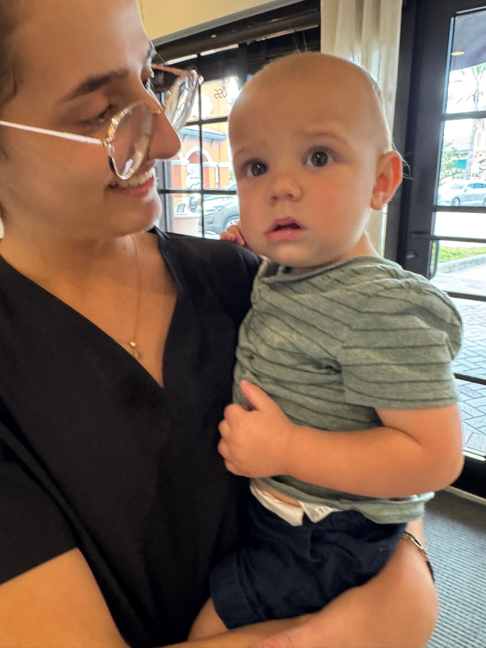 Yohanna with a curious baby in her arms at the clinic.