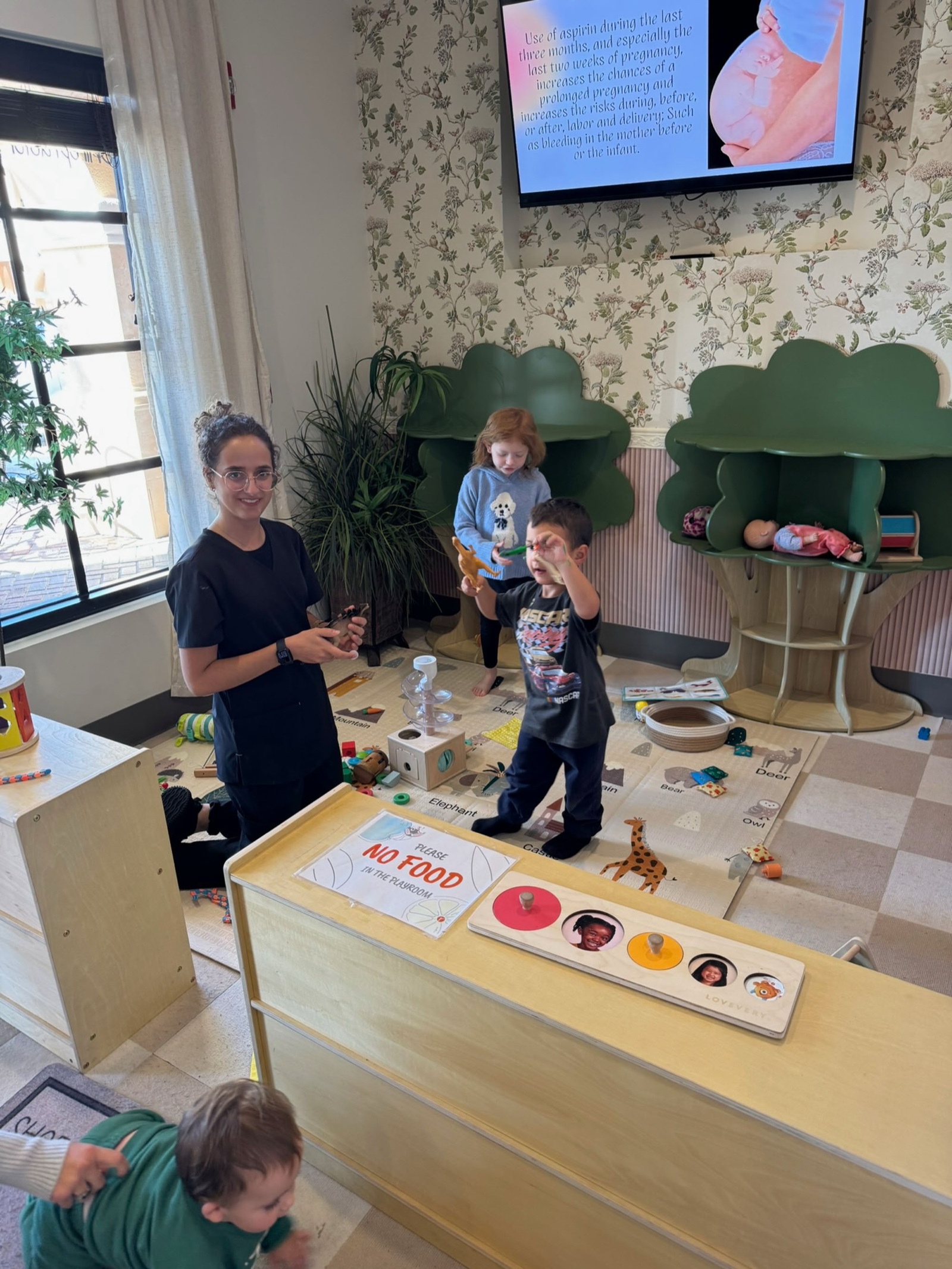 Yohanna engages with children in the Little Roots treehouse play room.